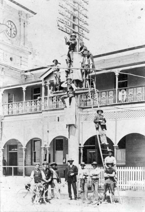 Telegraph pole at the front of the Mackay Post and Telegraph Office in River Street Mackay, c1920 