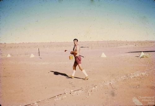 Pilot practising golf on the Birdsville airstrip, 1972