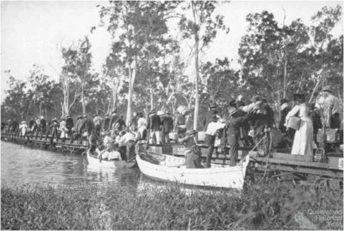 Railway passengers crossing Fitzroy River on flat wagons, c1900