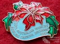Brisbane badges which include poinsettia motif, 1930-60