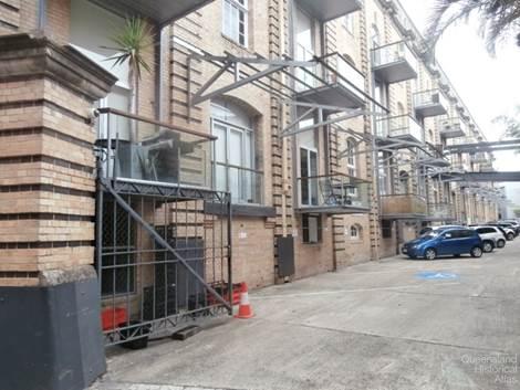 Apartment balconies facing car park of AML&F wool stores, 2014