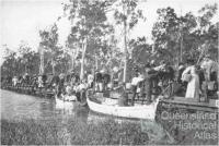 Railway passengers crossing Fitzroy River on flat wagons, c1900