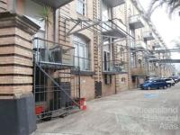 Apartment balconies facing car park of AML&F wool stores, 2014