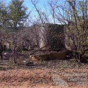 Stumps and corrugated iron tanks, Mungana